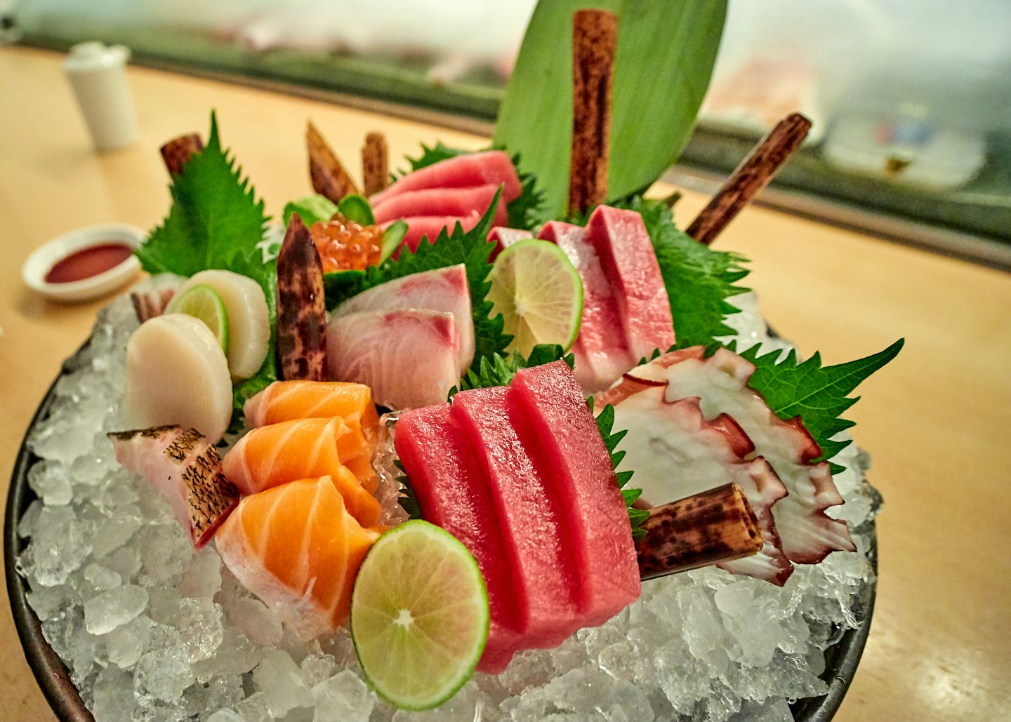 Assorted sashimi slices arranged on a bed of crushed ice.